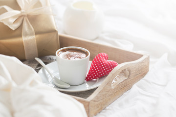 Romantic breakfast with coffee, cookies, gift box and red plush