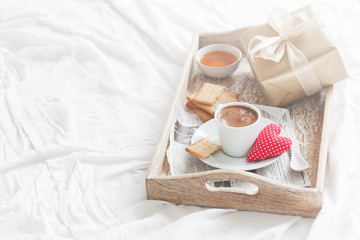 Fototapeta na wymiar Romantic breakfast with coffee, cookies, gift box and red plush