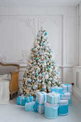 Christmas tree decoration at home interior with blue gift boxes