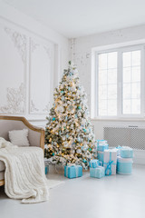 Christmas tree decoration at home interior with blue gift boxes