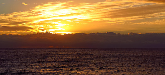 Panoramic sunrise over the clouds in the Mediterranean sea