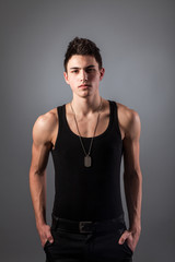 Fototapeta premium Muscular built man with a dog tags.