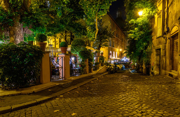 Fototapeta na wymiar Night view of old cozy street in Rome, Italy