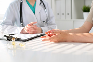 Doctor and patient are discussing something, just hands at the table
