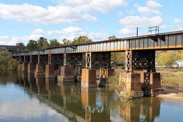Fototapeta na wymiar Railroad Bridge Reflected in James River in Richmond