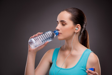 Woman doing sports with bottle of fresh water