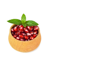 Pomegranate seeds in a wooden bowl