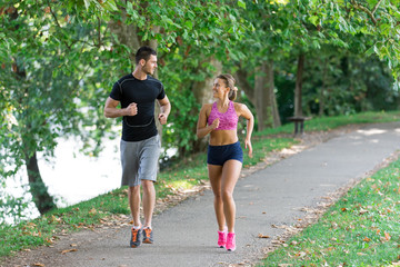 Fototapeta premium Young couple running in early morning at the park