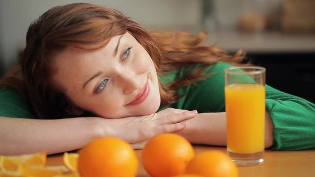 MH DS Woman Sitting at Table with Oranges and Orange Juice