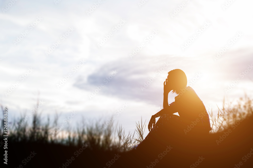 Wall mural Sad and depressed woman sitting alone - Wall murals