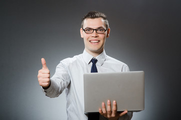 Man with laptop and thumbs up