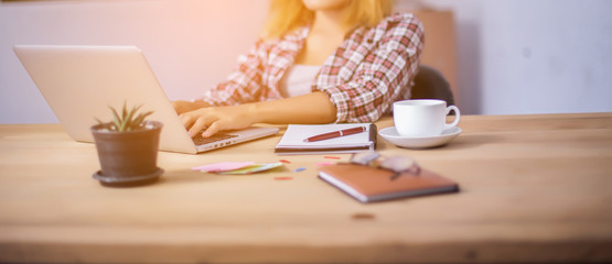 business woman writing something on notepad in office.