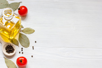 olive oil in jar on wooden background with spices