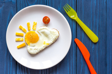 sunshine fried eggs breakfast for kid on blue background