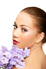 Naklejka premium Sensual young spa woman holding flower.