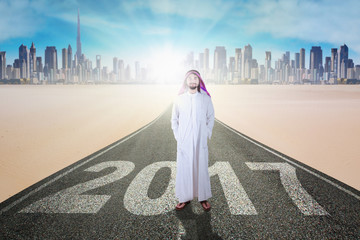 Business muslim standing on street with 2017