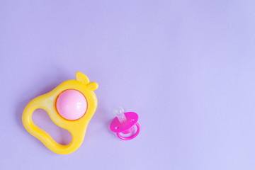 Fototapeta premium baby rattle on purple background