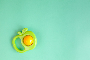 baby rattle on green background