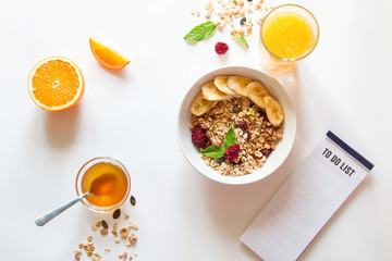 Breakfast with oatmeal and to do list on white background