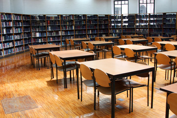 modern library: empty reading room with tables

