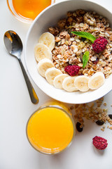 Breakfast with oatmeal and orange juice on white background