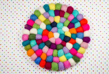 Colorful balls of wool.Felt handmade. Potholder with colorful beads.Colorful dots paper background.