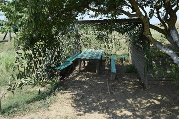 Camouflage Cape canopy over the gazebo and bench