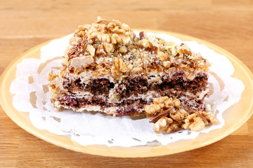 portion of white and brown chocolate walnut cake with walnuts