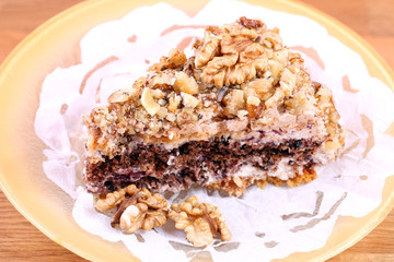portion of white and brown chocolate walnut cake with walnuts