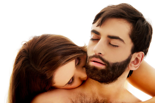 Beautiful woman kissing man's neck.