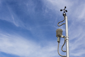 Anemometer in a farm with blue sky