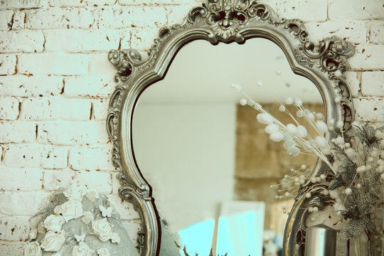 Vintage interior with a mirror in beautiful frame