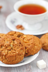 Cup of tea and oatmeal cookies with nuts, raisins  cinnamon