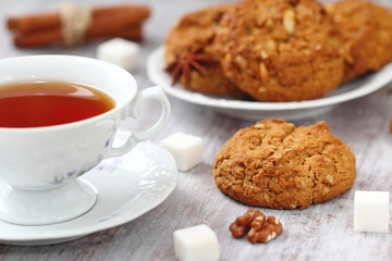 Cup of tea and oatmeal cookies with nuts, raisins  cinnamon