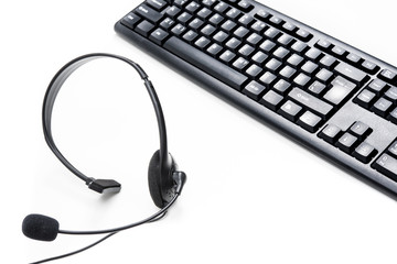 Microphone headset and computer keyboard on the table