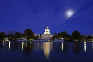 The Capitol Building in Washington DC at night with reflection in pond, capital of the United...