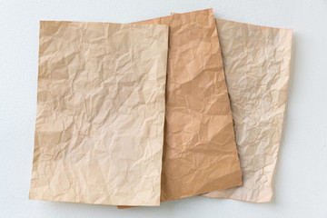 old three brown crumpled paper on stone wall background