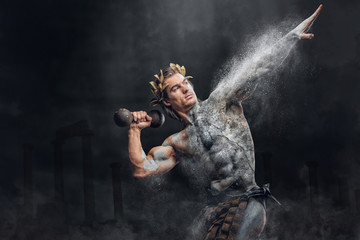 Crushing stone human athlete holds the dumbbel.