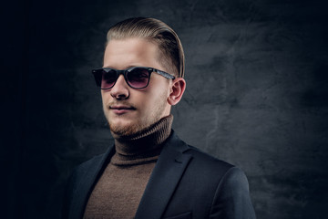 Obraz premium A man in sunglasses in turtle-neck sweate.