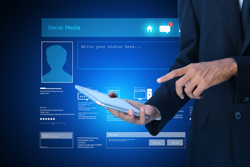  Man pointing the social network in tablet screen