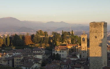 Fototapeta na wymiar Bergamo - Old city (Citta Alta). One of the beautiful city in Italy. Lombardia. Evening sunset. Landscape on the old city, clock towers and the fortress