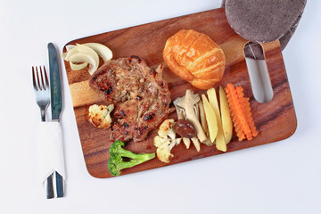 Home made ,Pork steak and mixed vegetables,croissants on butcher