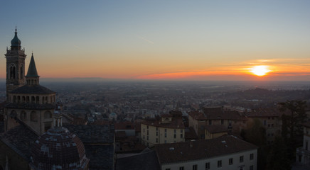 Fototapeta na wymiar Bergamo - Old city (Citta Alta). One of the beautiful city in Italy. Lombardia. Evening sunset. Landscape on the old city, Cathedral, clock towers and the Po Valley.