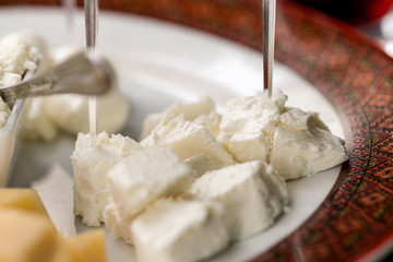 Feta cheese slices with skewers close up