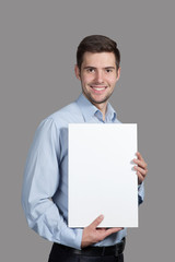 Portrait of a Man with a sign on a gray background