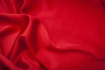 Valentine’s day concept with red rippled silk and copyspace in the smooth area, outside the ripple of the fabric there is space to copy text