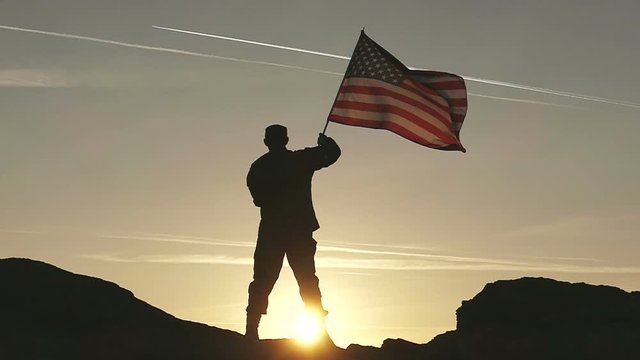 Soldier silhouette and American Flag in Slow Motion. 