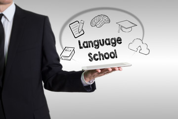 Language School concept with young man holding a tablet computer