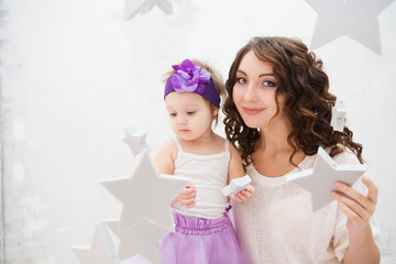 Happy loving family. mother and child girl playing and hugging

