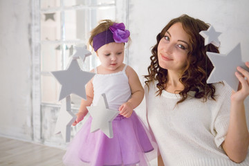 Happy loving family. mother and child girl playing and hugging

